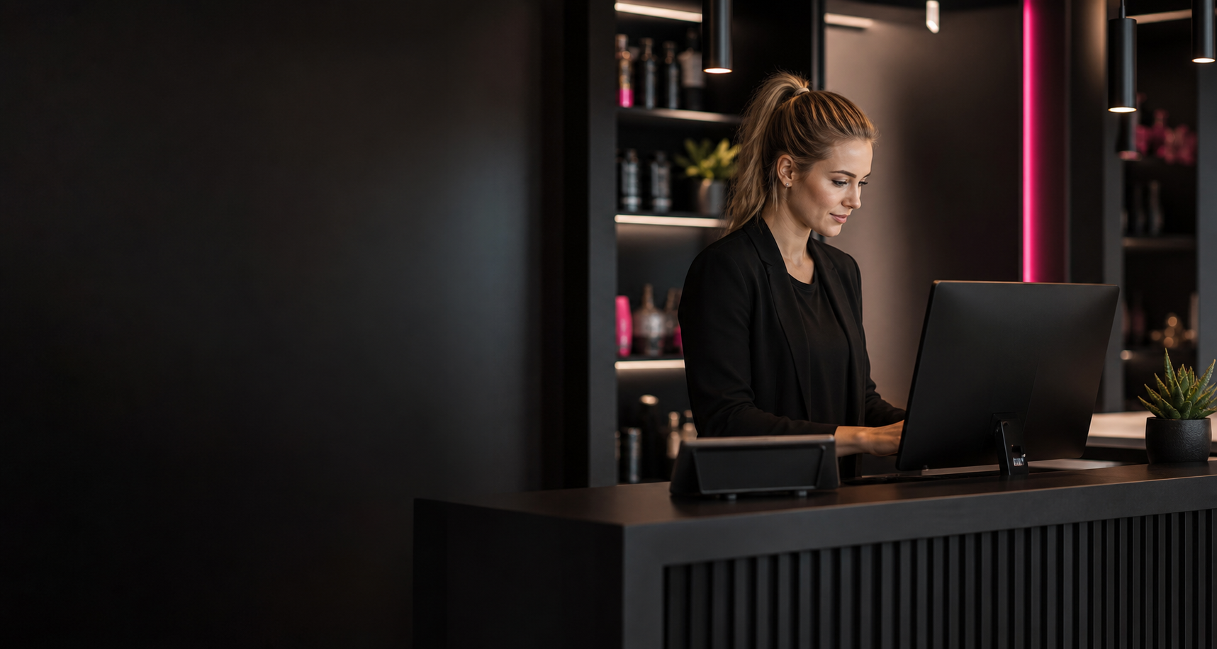 Salon manager working at a modern reception desk